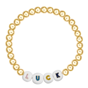 Close-up of golden beaded luck bracelet with colorful letter beads on white background