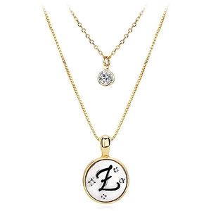 Close-up of layered gold letter Z pendant necklace with zircon stones and box chain