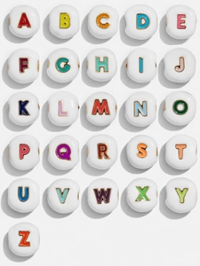 Macro detail of colorful enamel A-Z alphabet beads for personalized DIY jewelry making
