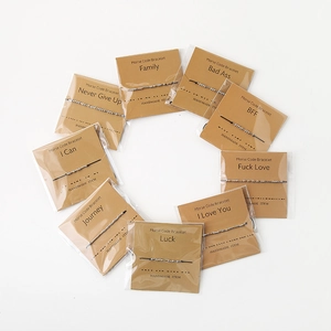 Detailed view of Morse code bracelets featuring beads and cords on kraft paper cards
