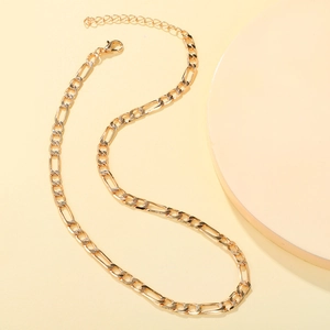 Detail of gold-plated Figaro chain necklace with lobster clasp and adjustable links
