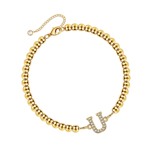 Adjustable golden beaded bracelet featuring a sparkling micro-pave letter U charm