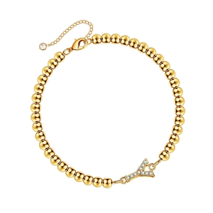 Gold beaded bracelet featuring a sparkling crystal-encrusted letter Y pendant charm