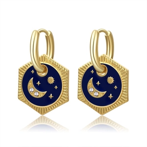Detail of gold celestial earrings with blue enamel, star and moon charms
