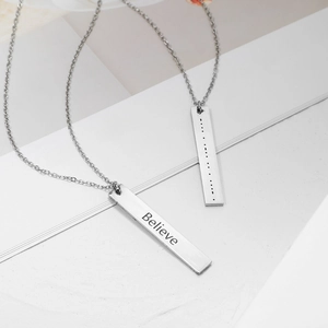 Detail showing stainless steel pendants with Believe engraving and Morse code symbols