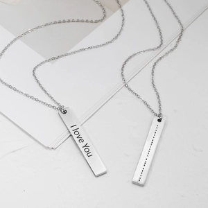Detail view of Morse code and I Love You engraved on stainless steel pendant necklaces