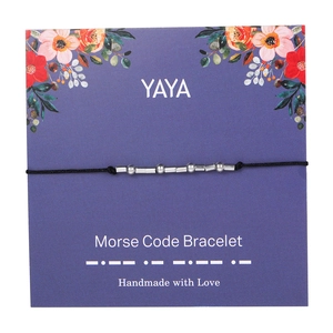 Detailed view of silver Morse code bracelet on purple floral card with handmade beads