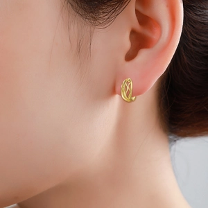 Minimalist gold-plated hollow vine pattern earrings worn on model's ear for an elegant look