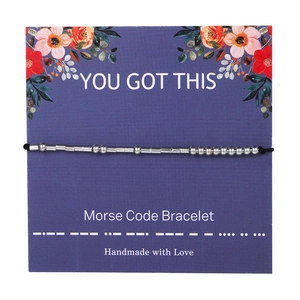 Minimalist Morse Code Bracelet on decorative card featuring silver beads and black cord