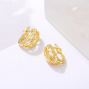 Minimalist gold-plated hollow vine pattern hoop earrings shown on white marble background