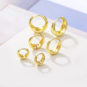 Three pairs of gold-plated hoop earrings in various sizes with polished finish