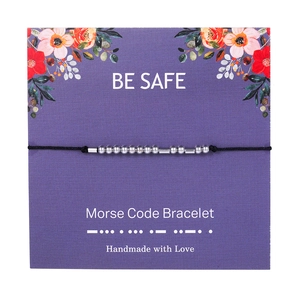 Detail of Morse code braided bracelet with BE SAFE message on card packaging