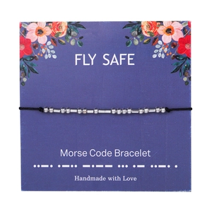 Detail of Morse code bracelet on FLY SAFE card with silver beads and black cord