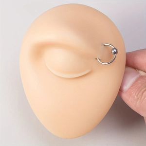 Close-up of a captive bead stainless steel nose ring on a realistic silicone model