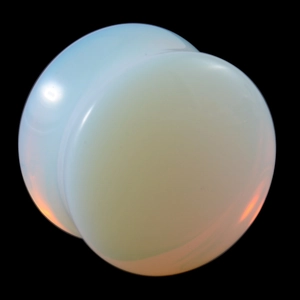 Polished opalite double flare ear gauges with glowing milky blue translucent finish