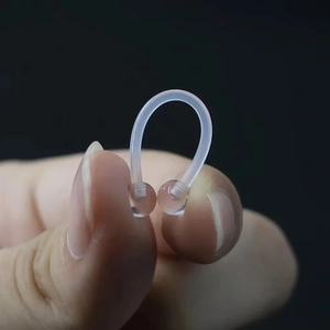 14G flexible bioflex horseshoe septum ring with clear balls shown held between fingers