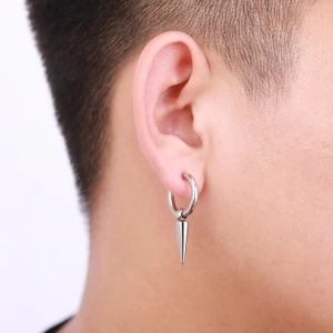 Close-up of minimalist punk style silver stainless steel hoop earring with cone pendant