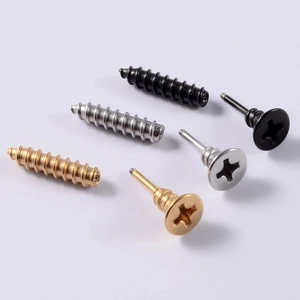 Macro detail of screw-shaped stud earrings in black, silver, and gold stainless steel
