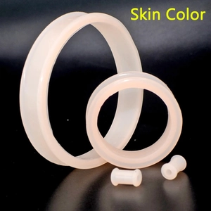 Macro view of skin color flexible silicone double flared ear tunnels jewelry