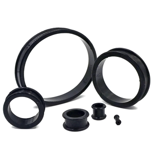 Macro detail of flexible black silicone ear tunnels showing multiple size options