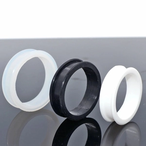 Three pairs of soft silicone double flared ear tunnels in white, black and translucent