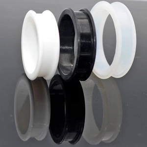 Detailed view of flexible silicone double flare tunnels in black white and clear colors