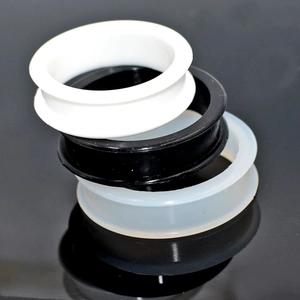 Three oversized flexible silicone double flared ear tunnels in black, white, and translucent