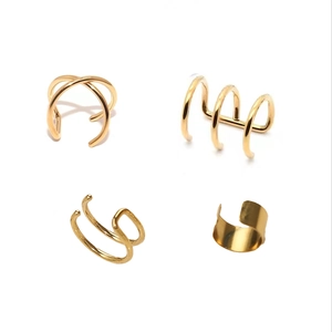 Macro detail of 4pcs gold non-pierced ear cuffs in various minimalist geometric designs
