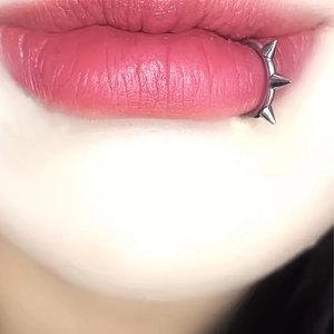 Silver non-piercing lip ring set with three punk style spikes shown on model lip