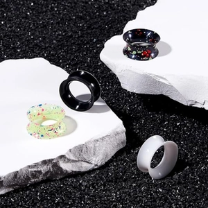 8-piece silicone double flared ear gauges with solid and speckled splatter patterns