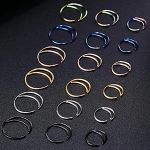 Stainless steel moon nose rings in various colors and sizes on black background