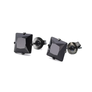 Macro shot of square black zircon stud earrings with faceted surface and black metal base