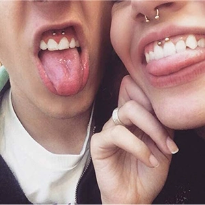 Stainless steel horseshoe septum rings and smiley piercings set on models