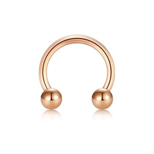 Detail of rose gold circular barbell nose ring with reflective surface on white background