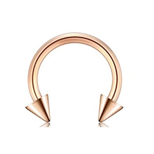 Detailed macro view of a rose gold horseshoe piercing ring with sharp conical spikes