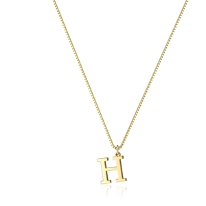 Macro shot of polished gold-plated letter H pendant on a delicate box chain necklace