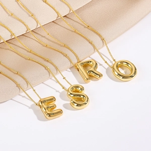 Polished 3d bubble initial letter pendants on a dainty gold beaded chain necklace