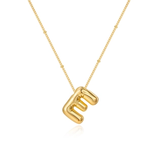 Detail of puffy bubble letter E gold necklace featuring a starburst engraving design