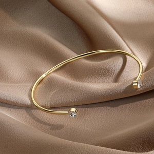 14k gold plated minimalist open bangle featuring two round clear cubic zirconia stones