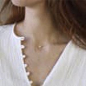Close-up of minimalist gold plated zircon necklace on neck for elegant daily styling