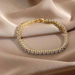 Detail of 14k gold plated tennis bracelet with sparkling cubic zirconia on silk