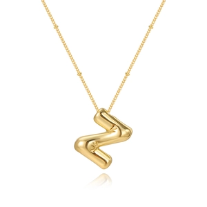 Detailed macro view of a 3D bubble gold letter Z pendant with small star-shaped engravings