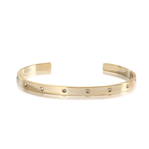 Macro detail of 14k gold plated cuff bracelet featuring sparkling inset round crystals