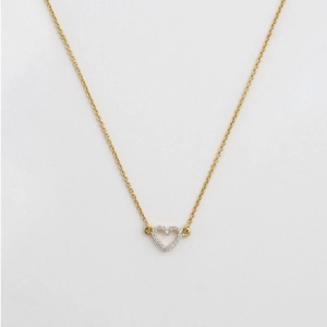 Detailed close-up of a 18K gold hollow heart pendant with sparkling white cubic zirconia