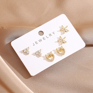 Detailed view of 16K gold plated stud earring set with zircon stars and hearts