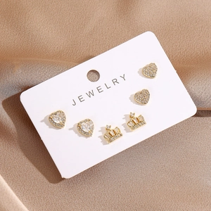 Detailed close-up of 16K gold plated earring set with heart and crown crystal studs