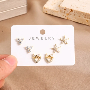 Close-up of 16K gold plated earring set with zircon heart, star and flower designs