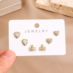 Detailed view of 16K gold plated earring set featuring crown and heart zircon designs