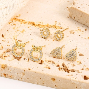 Macro detail of three-pair 16K gold plated stud earrings set with crystal zircons