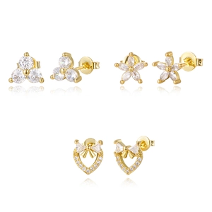 Macro detail of three pairs of 16K gold-plated stud earrings with zircon inlays